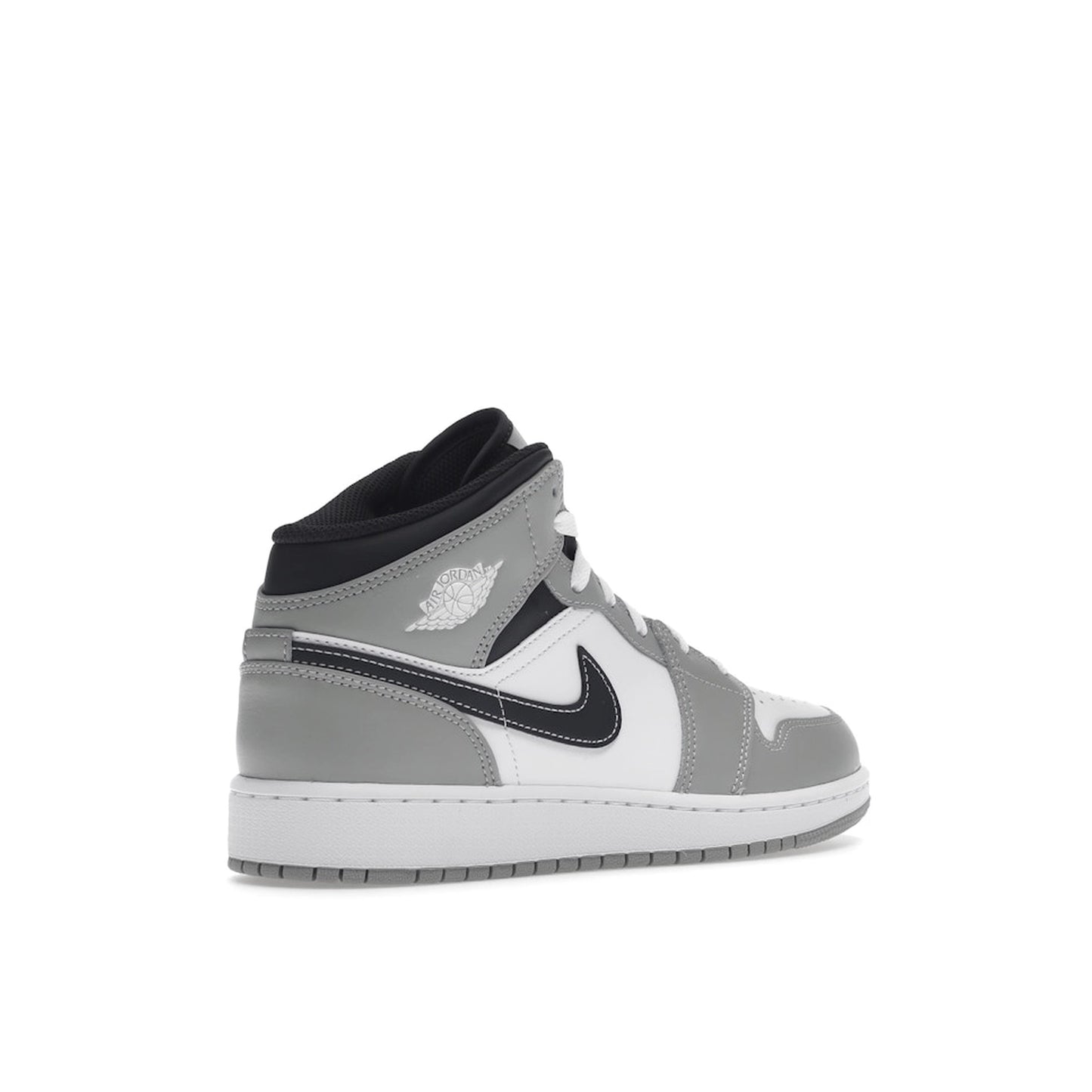 Jordan 1 Mid sneakers (GS), back view, model 554725-078, in light smoke grey with black and white accents.