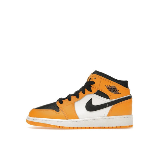 Jordan 1 Mid GS sneakers, side view, in yellow and black with classic Jordan design.