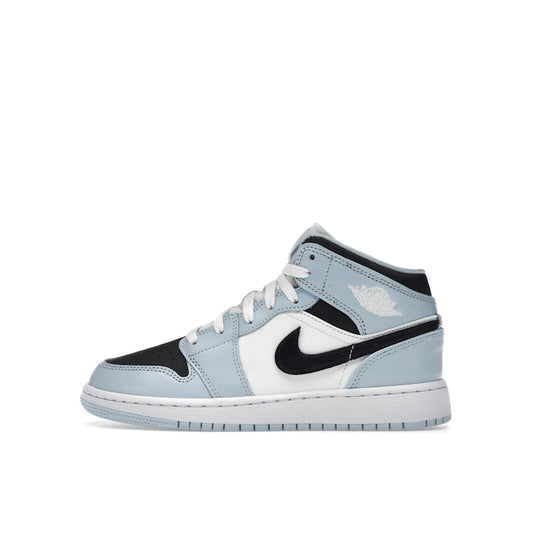 Jordan 1 Mid Ice Blue GS sneakers, side view, in ice blue with white and black details.