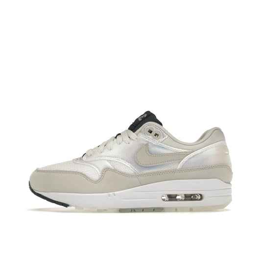 Nike Air Max 1 AMD La Ville Lumière Women's sneakers, side view, model DQ9326-100 in white with light accents.
