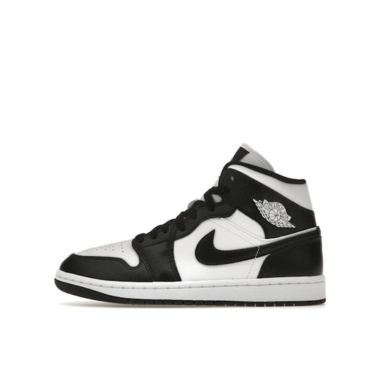 Jordan 1 Mid Women’s sneakers, side view, in white with black panda-style overlays.
