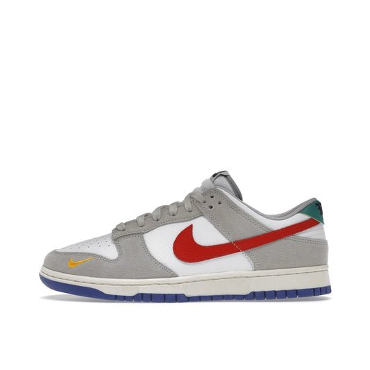 Nike Dunk Low sneakers, side view, model DV3497-001 in light iron ore with red and blue details.