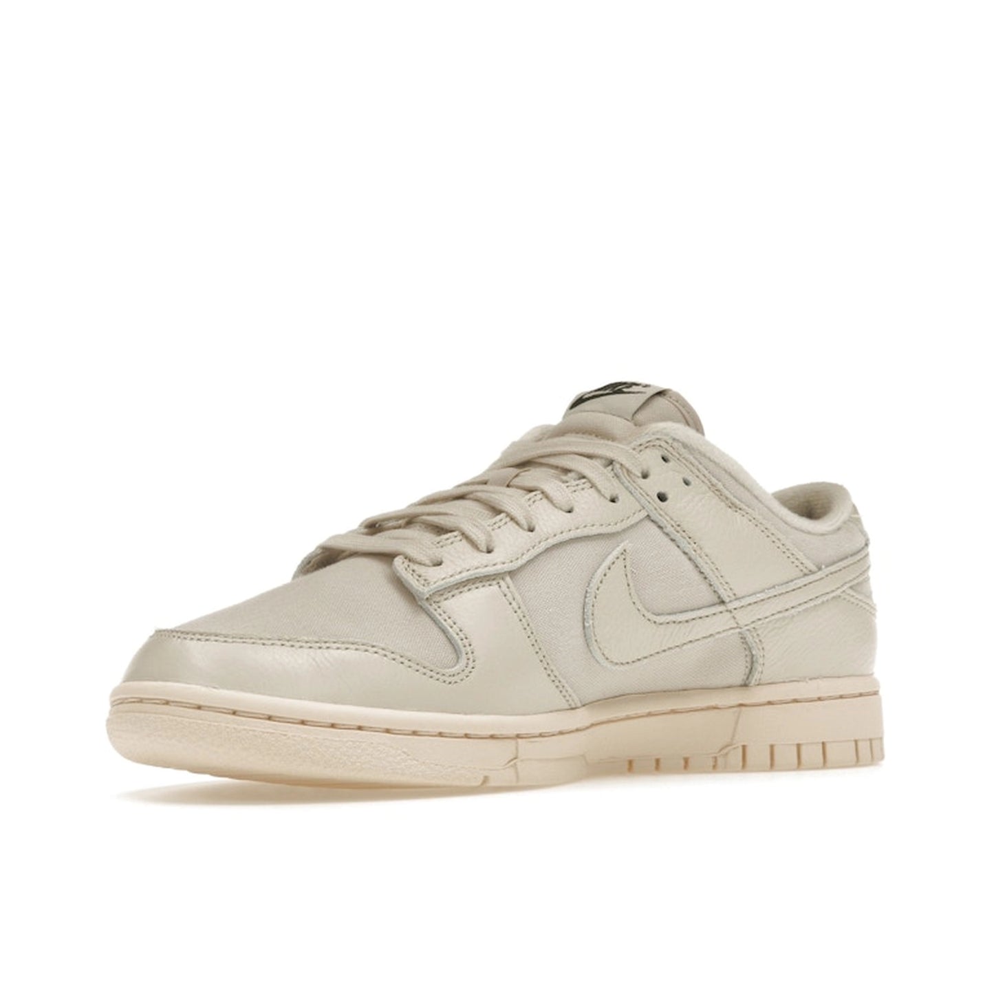 Nike Dunk Low Premium sneakers, front view, model DZ2538-100, in light orewood brown with white and beige accents.