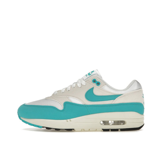 Nike Air Max 1, side view, in white and teal green with neutral grey accents.