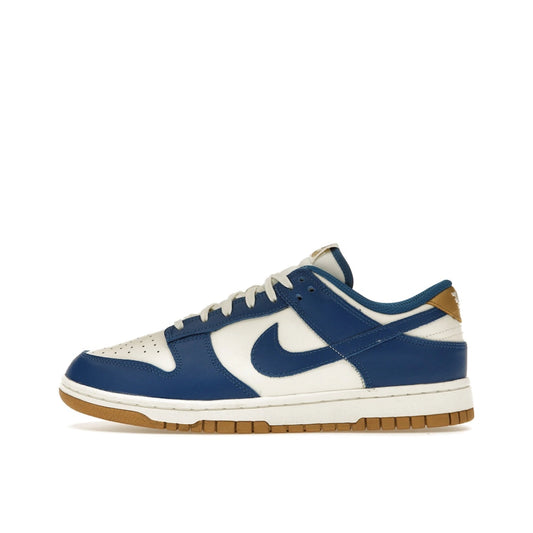 Nike Dunk Low Kansas City Royals Women’s sneakers, side view, in white and royal blue.