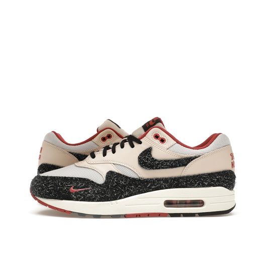 Nike Air Max 1 Keep Rippin Stop Slippin 2.0 sneakers, side view, model FD5743-200, black and beige with red accents.
