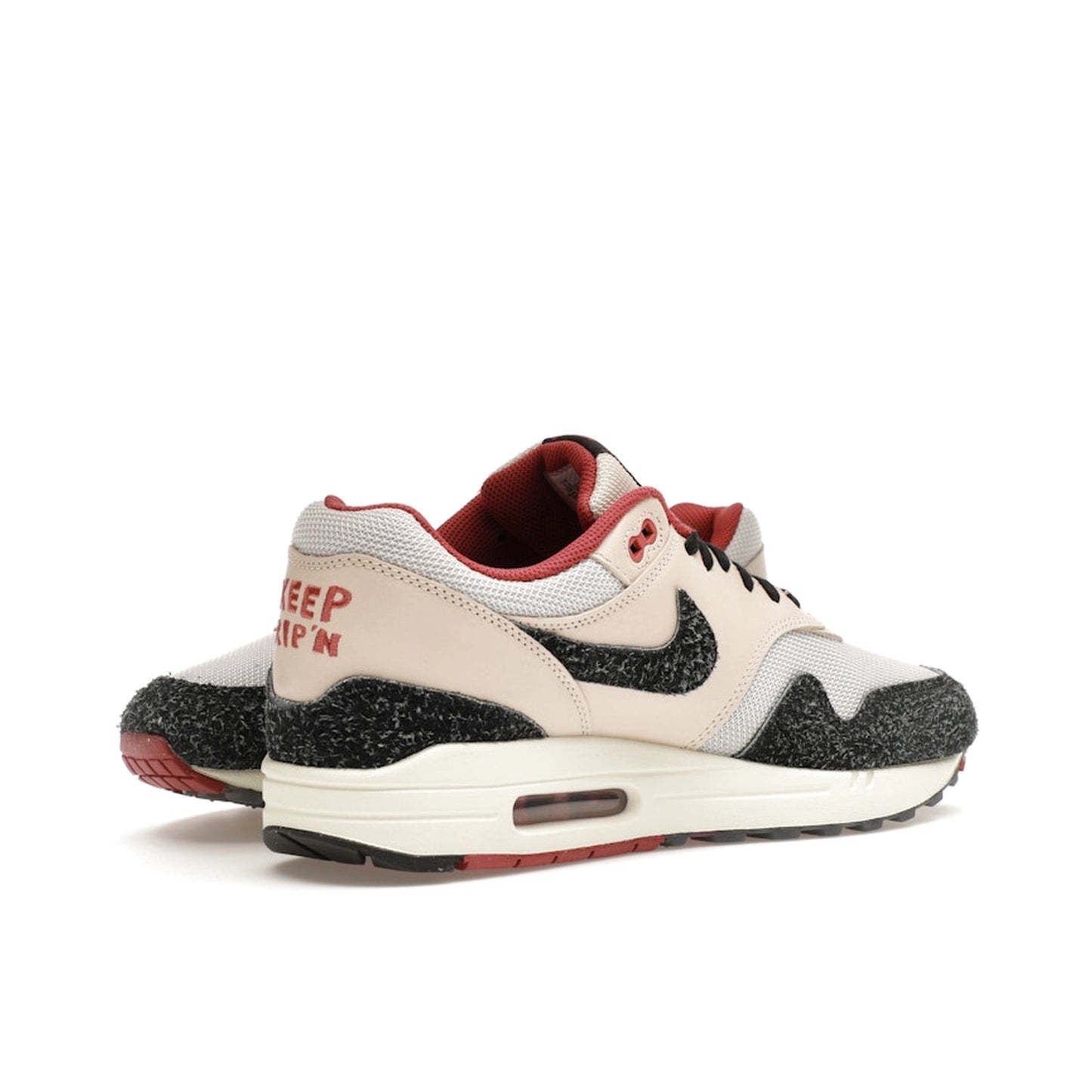 Nike Air Max 1 Keep Rippin Stop Slippin 2.0 sneakers, front view, model FD5743-200, black and beige with red accents.
