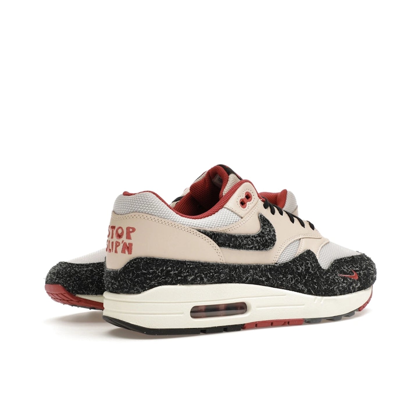 Nike Air Max 1 Keep Rippin Stop Slippin 2.0 sneakers, back view, model FD5743-200, black and beige with red accents.