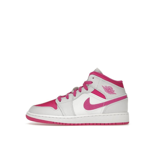 Jordan 1 Mid Fire Pink GS sneakers, side view, model FD8780-500, in vibrant fire pink with white accents.