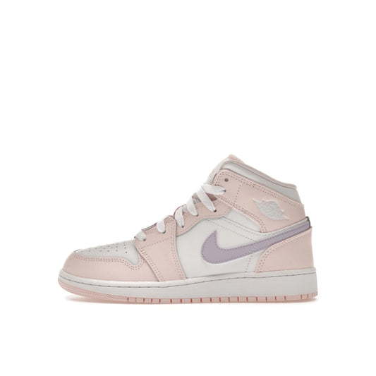 Jordan 1 Mid GS sneakers, side view, in pink wash with white accents.