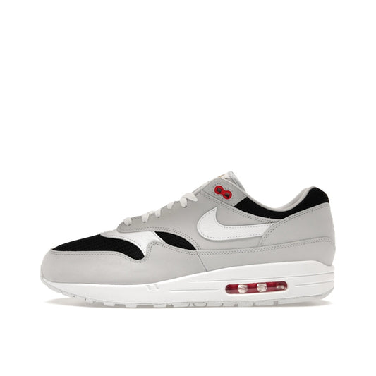 Nike Air Max 1 Urawa 2023 sneakers, side view, model FD9081-001 in grey, black and red details.