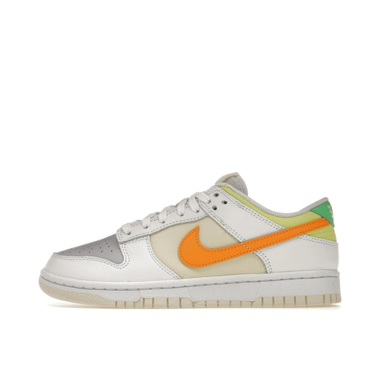 Nike Dunk Low Sundial sneakers, side view, model FJ4742-100 for women in white and sunrise color.