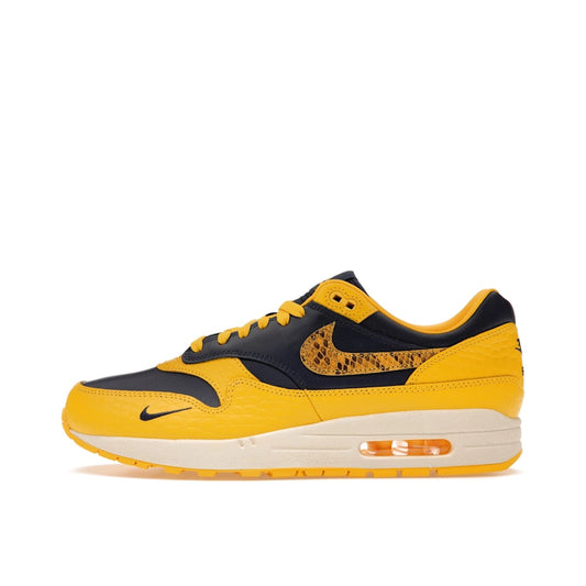 Nike Air Max 1 CO.JP Michigan Women’s sneakers, side view, in navy blue and maize yellow.