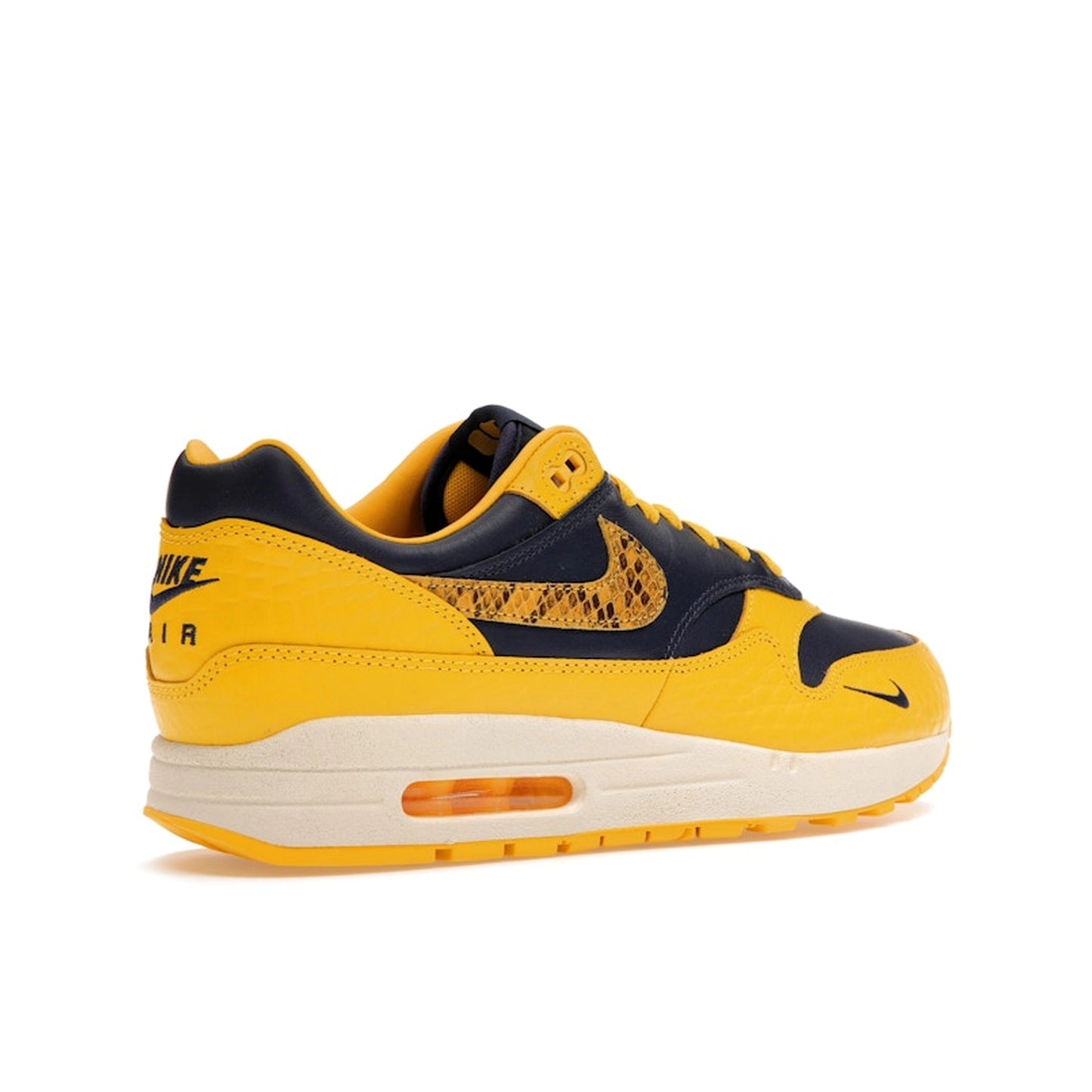 Nike Air Max 1 CO.JP Michigan Women’s sneakers, back view, in navy blue and maize yellow.