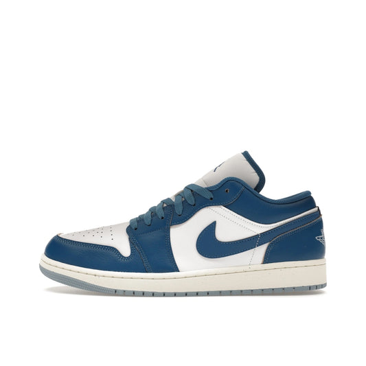 Jordan 1 Low Industrial Blue sneakers, side view, in white with blue and black details.