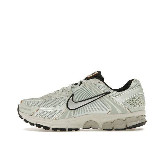Nike Zoom Vomero 5 Light Silver Chrome, side view, in tonal silver with reflective chrome details.