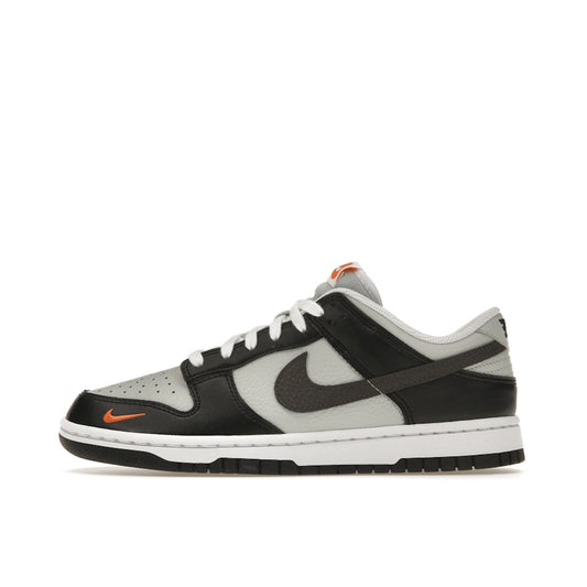 Nike Dunk Low Black Total Orange Mini Swoosh sneakers, side view, model FN7808-001 in black and orange.