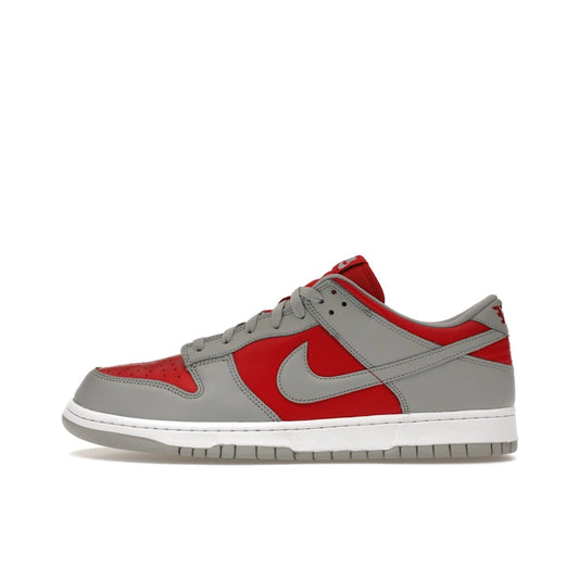 Nike Dunk Low QS Reverse Ultraman, side view, red leather upper with metallic silver overlays.