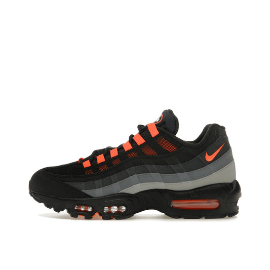 Nike Air Max 95 Black Hyper Crimson, side view, in mesh and suede with orange-red highlights.