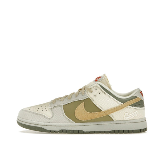 Nike Dunk Low Women's sneakers, side view, model FZ4341-100, in light bone with dark stucco and white accents.
