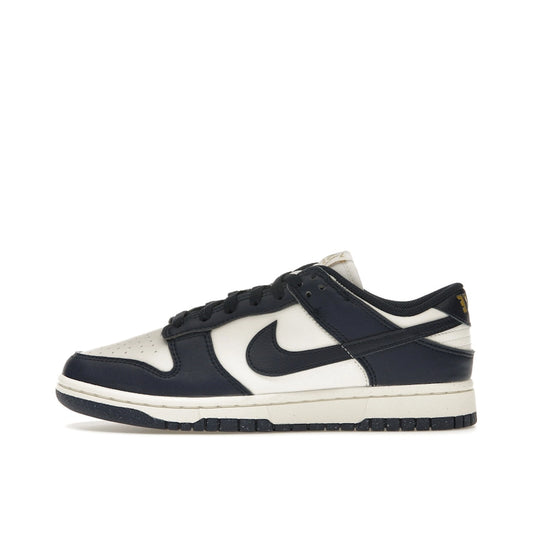 Nike Dunk Low Next Nature Women’s sneakers, side view, in Olympic-inspired dark blue and gold.