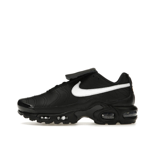 Nike Air Max Plus Tiempo, side view, in black leather with white swoosh and sole.