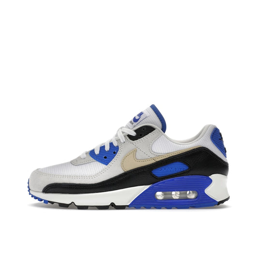Nike Air Max 90 Racer Blue, side view, in white leather with grey suede and blue branding.