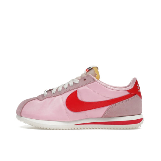 Nike Cortez TXT Medium Soft Pink Sail, side view, tonal pink textile upper with off-white sole.