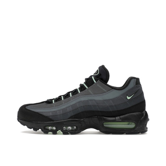Nike Air Max 95 sneakers, side view, in black and grey with vapor green accents.