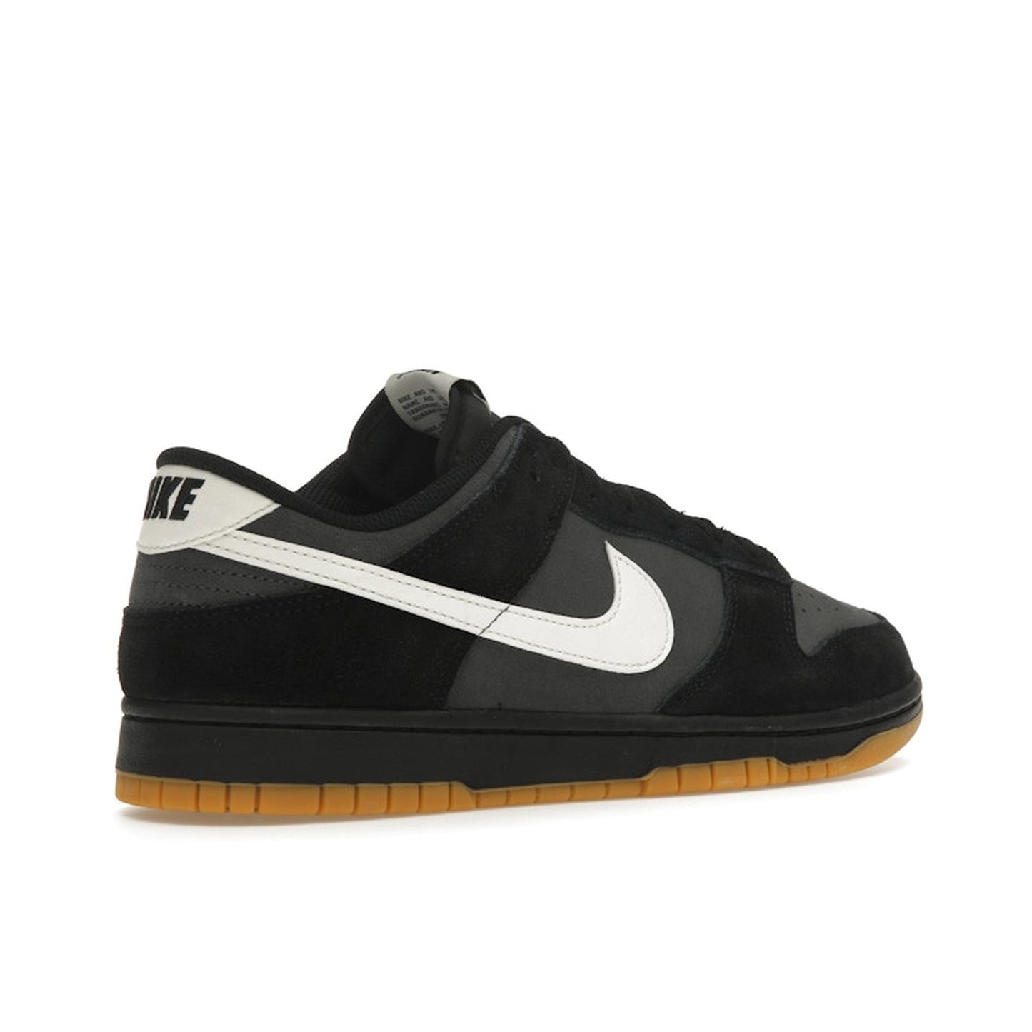 Nike Dunk Low SE, back view, in black and grey leather with gum sole.