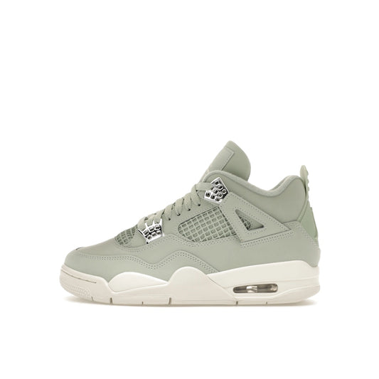 Air Jordan 4 Retro Women’s sneakers, side view, in seafoam green with metallic details.