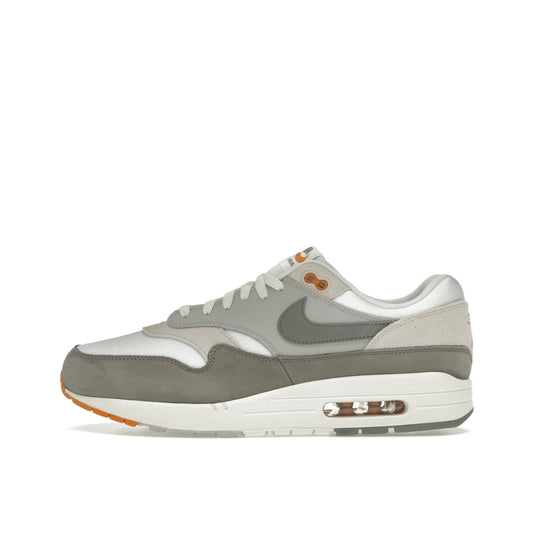 Nike Air Max 1 Light Iron Ore, side view, featuring mesh base and grey suede panels.