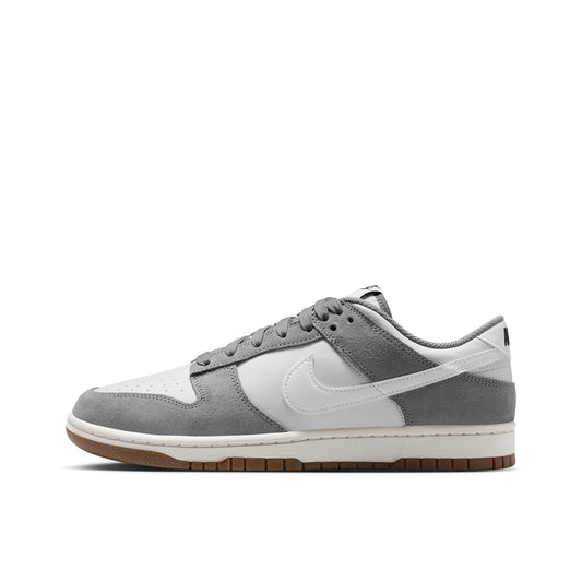 Nike Dunk Low Retro SE Cool Grey, side view, in light grey and white with suede overlays.