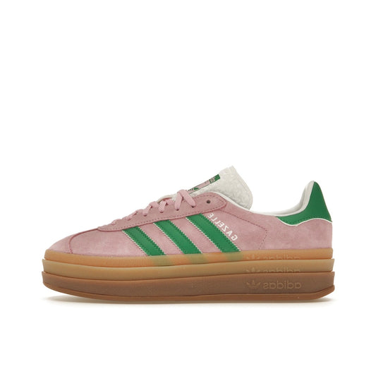 adidas Gazelle Bold Women’s sneakers, side view, in true pink with green stripes and platform sole.