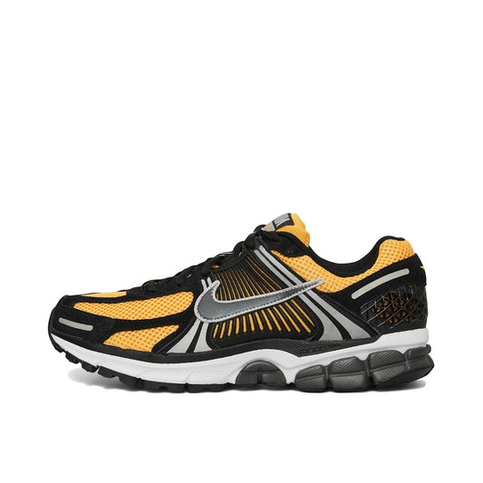 Nike Zoom Vomero 5 Sundial, side view, in yellow-orange with mesh and layered panel design.