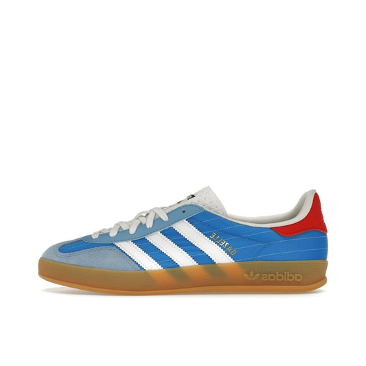 adidas Gazelle Indoor Olympic Blue, side view, in bright blue suede with classic white three stripes.