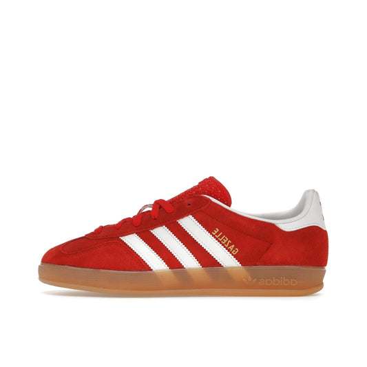 adidas Gazelle Indoor Women’s sneakers, side view, in better scarlet with white stripes and gum sole.