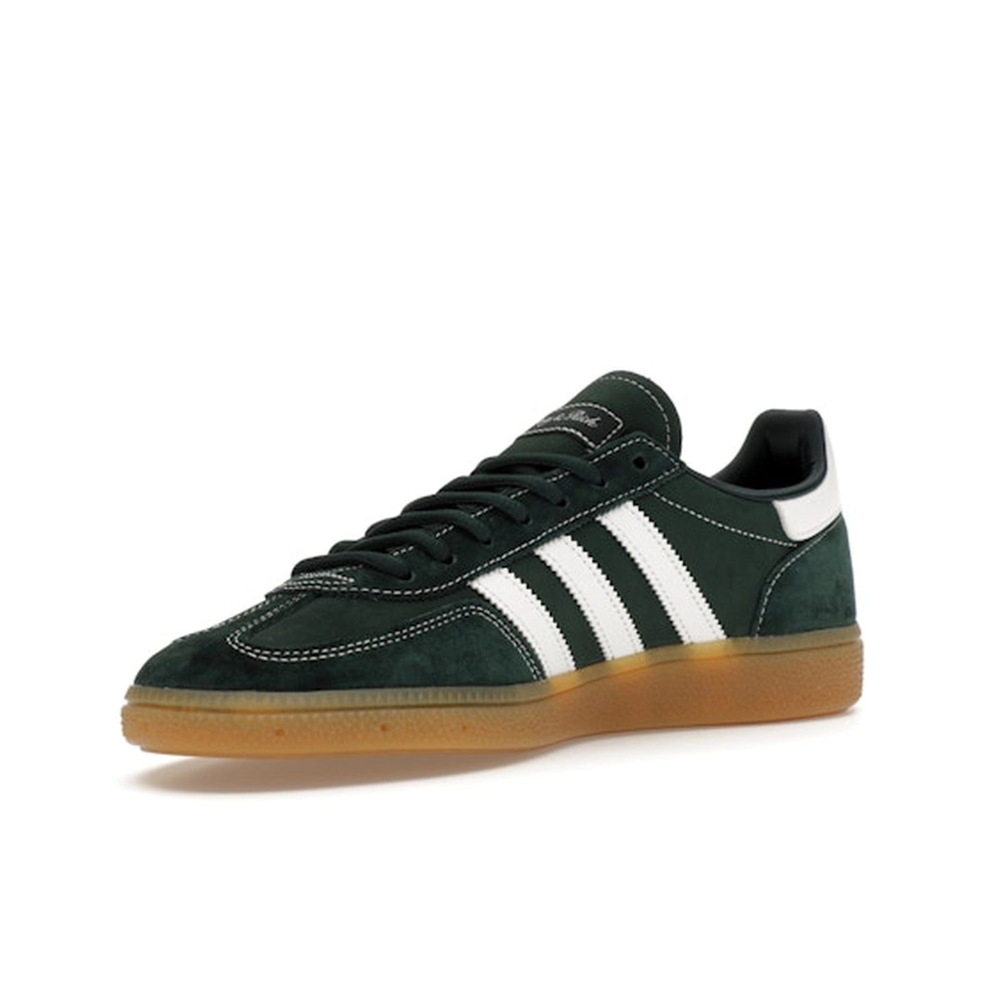 adidas Handball Spezial Sporty & Rich, front view, in deep green suede with white three stripes.