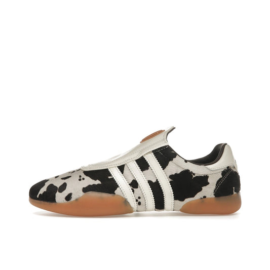 adidas Taekwondo Mei Women’s sneakers, side view, in white with black cow print details.
