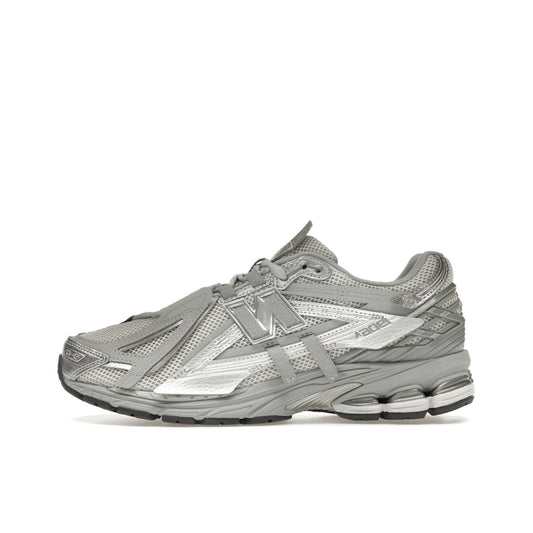 New Balance 1906A Concrete Silver Metallic, side view, layered silver panels with reflective details.