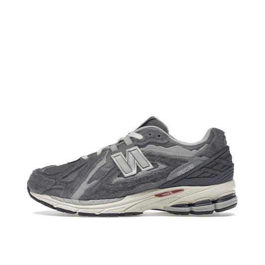 New Balance 1906D Protection Pack sneakers, side view, model M1906DA in harbor grey with black and white details.