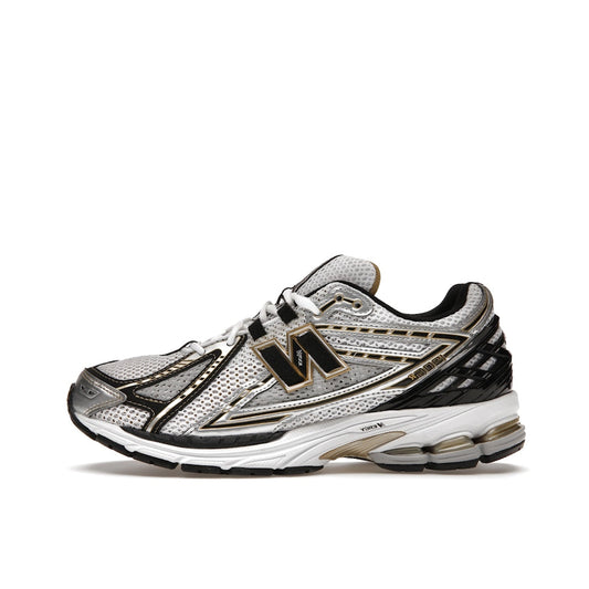 New Balance 1906R, side view, in white mesh with metallic gold overlays.