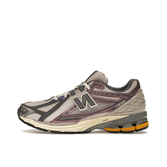 New Balance 1906R Licorice, side view, in rich brown tones with metallic accents and sporty design.
