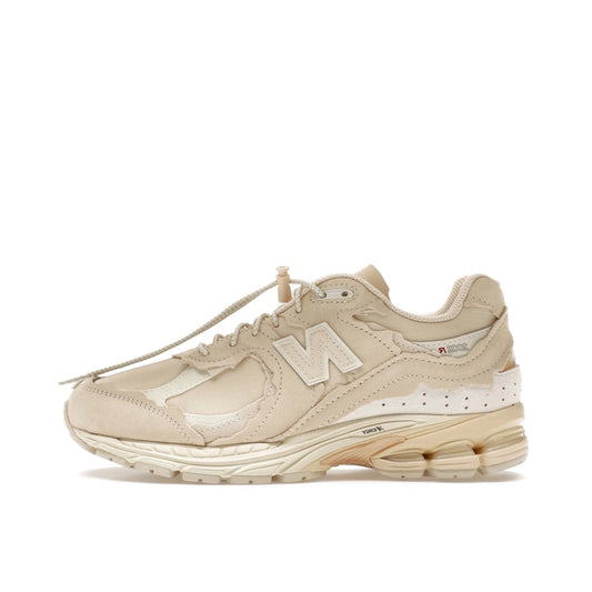 New Balance 2002R Protection Pack sneakers in Sandstone, side view, model M2002RDQ in beige.