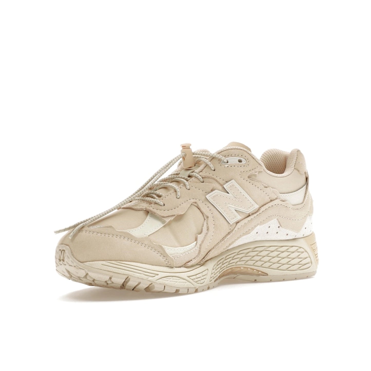 New Balance 2002R Protection Pack sneakers in Sandstone, front view, model M2002RDQ in beige.