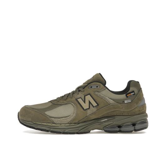 New Balance 2002R, side view, in olive with Cordura fabric and tonal overlays.