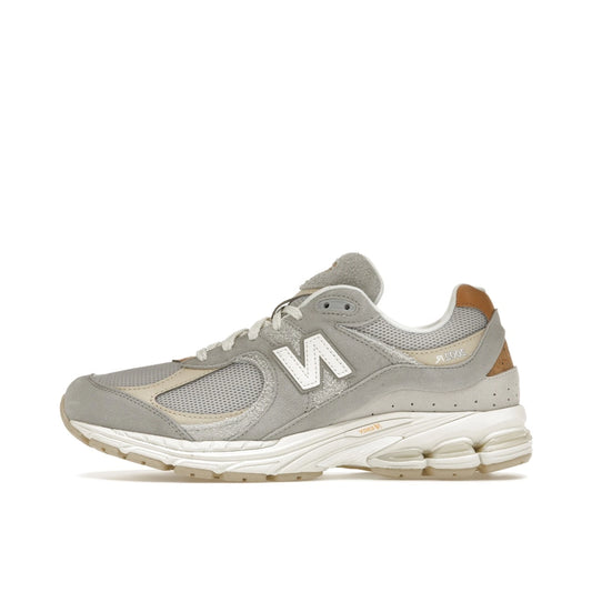 New Balance 2002R Concrete Grey sneakers, side view, in grey with tonal overlays.