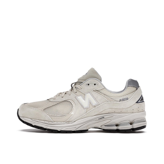 New Balance 2002R sneakers, side view, model ML2002RE, in bone with light aluminum accents.
