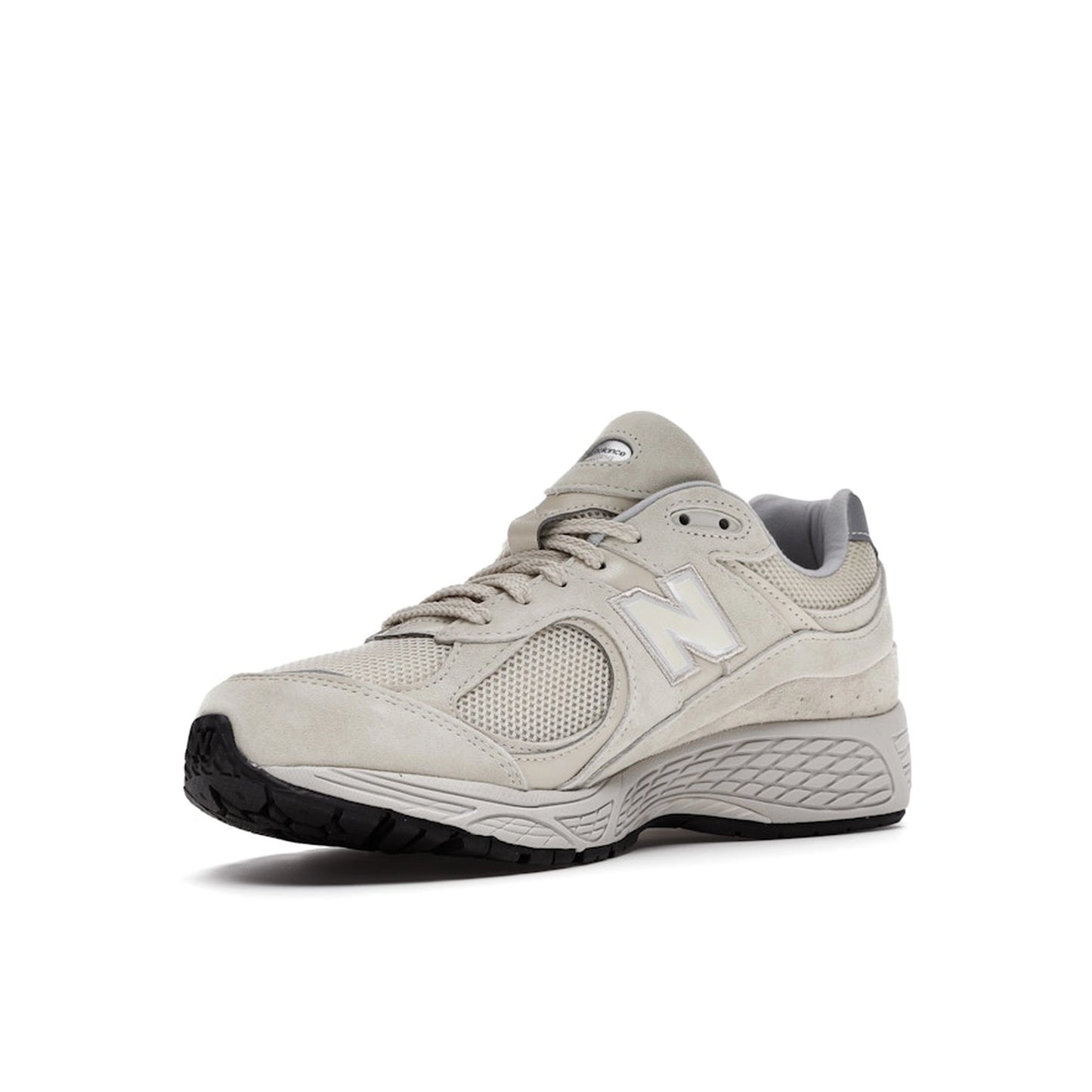 New Balance 2002R sneakers, front view, model ML2002RE, in bone with light aluminum accents.