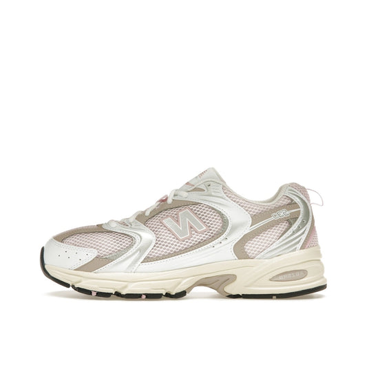 New Balance 530 Pink Granite, side view, in pastel pink tones with grey and white details.